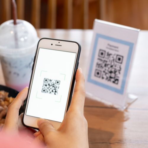 Customer scanning QR code at table