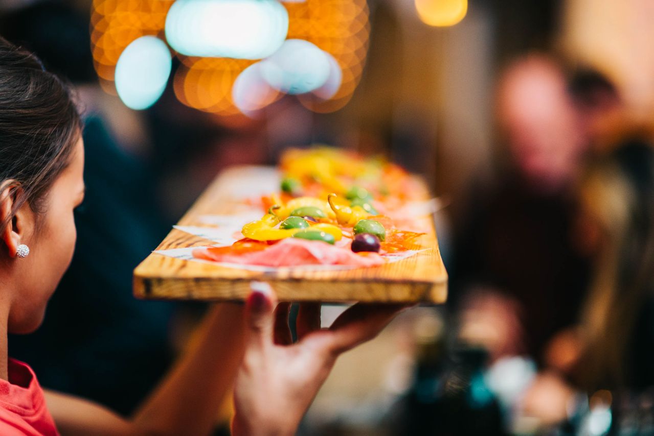 Restaurant server attending to a guest